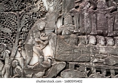 Details Of The 12th Century Relief Of Bayon Temple With Life Of Ancient People, Cambodia. Historical Artwork On Wall Of Khmer Landmark In Angkor. UNESCO World Heritage Site.