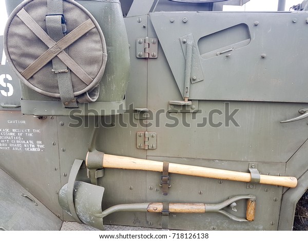 Details of ancient army tank shovels\
and equipment stored on side of truck and running\
board