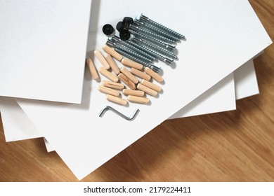 details for assembling furniture close-up on the details of cabinet furniture from laminated chipboard background, fasteners - Shutterstock ID 2179224411