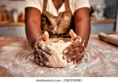 Details in baking process. Close up of black female hands molding raw dough on wooden table powdered with flour. Experienced housewife working accurate with bread base to fill with air for softness. - Powered by Shutterstock