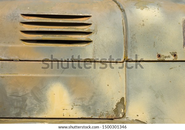 Details of\
the bonnet of a Soviet military truck. Detail of an old camouflage\
surface with exfoliated paint on a military truck. Car detail.\
Military metal background.\
Close-up