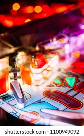 Details Of A Bright And Colorful  Pinball Arcade Game Board Lid With Neon Lights In A Gaming Room