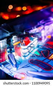 Details Of A Bright And Colorful  Pinball Arcade Game Board Lid With Neon Lights In A Gaming Room