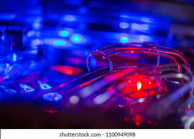 Details Of A Bright And Colorful  Pinball Arcade Game Board Lid With Neon Lights In A Gaming Room