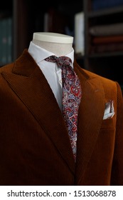 Details of brown corduroy bespoke jacket with tie. Close-up	
