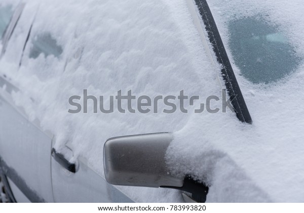 Details of a car covered with\
snow