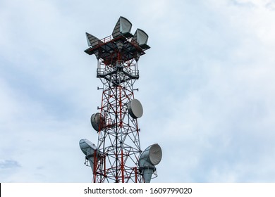 Details Of A Cellular Base Station GPS Tower For Exchange Of Radio Signals And Geolocation Data, Housed On A Red And White Steel Lattice Pylon