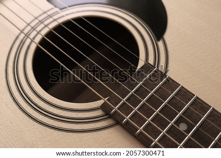 Details of classic acoustic guitar, strings and chords, guitar neck close up.