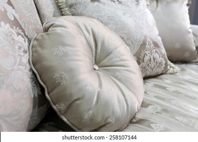 Details Of A Colorful Round Cushion On A Bed