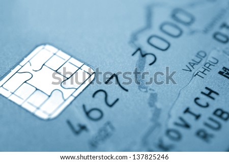 Details of a credit card with chip and numbers. Macro.