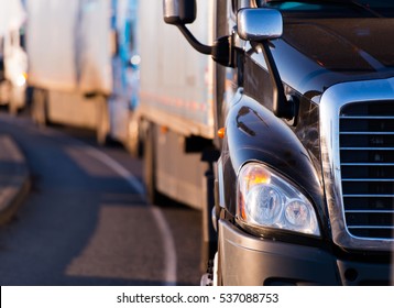 Details Of Dark Semi Truck On The Road On Blured Truck And Trailer Background