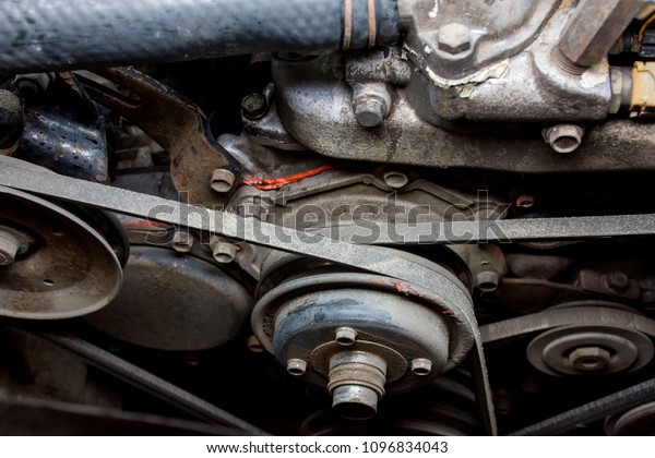 Details of a dirty diesel engine under the hood of an\
old car