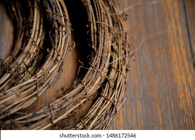 Details of dry vine circle wreaths on distressed wooden surface background. Closeup of grapevine twigs texture. Natural backdrop in shades of brown. Woven vine textures on grunge board backdrop. - Powered by Shutterstock