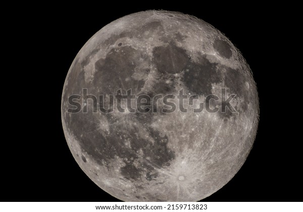 Details of the full moon\
photographed by a telescope, craters and mountains are visible far\
away.