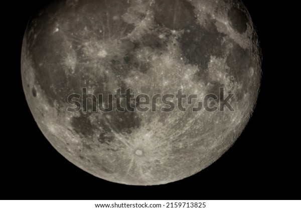 \
Details of the full moon\
photographed by a telescope, craters and mountains are visible far\
away.