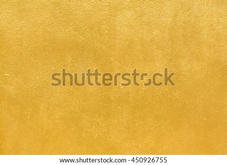 Details of golden texture background. Gold color painted on cement wall  for background and wallpaper