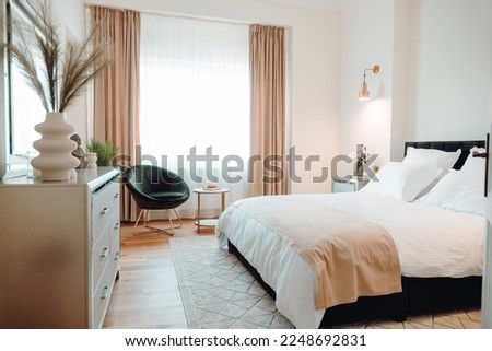 Details of high end home design with exquisite furniture, wooden floors and modern carpet. Master bedroom design