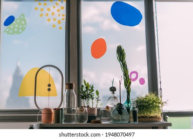 Details Of A Modern Eco Kitchen With Lots Of Greenery. Parts Of The Kitchen Interior, Dishes, Many Sprouts And Sprouts On The Shelf By The Window In The Sunlight.