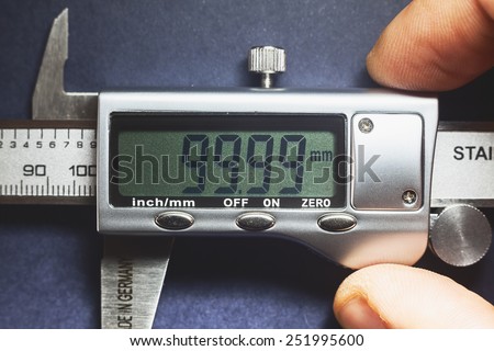 Details of modern measuring tool, digital display showing precise dimension in two decimals. 