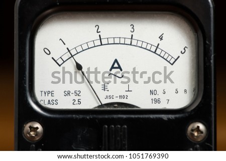 Details of an old black analog ampere meter, scale and indicator