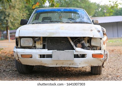 Details Of An Old Rusted Crash White Car, Front View