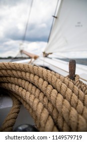 Details Of An Old Sailing Boat / Schooner With White Sail, Wood, Steel And Ropes