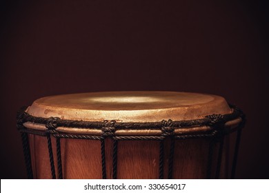 Details of an old wooden djembe, closeup view on ropes, skin and wood.  - Powered by Shutterstock