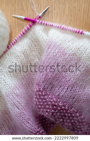 Details of pink and white ombre mohair hand knitted sweater with  stitches including stocking stitch and moss or seed stitch, knitted on circular needles. 