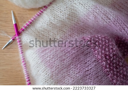Details of pink and white ombre mohair hand knitted sweater with  stitches including stocking stitch and moss or seed stitch, knitted on circular needles. 