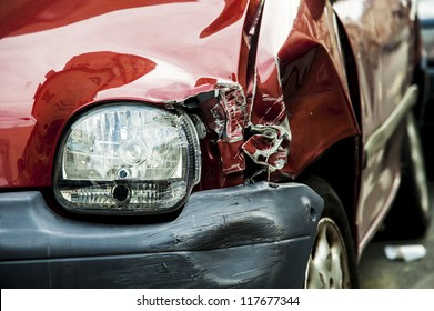 Details of a red car in an accident