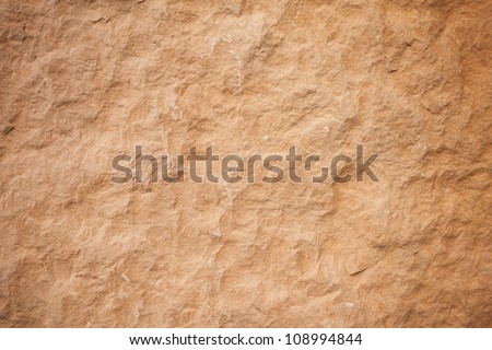 Details of sand stone texture, closeup shot of rock surface with vignette at cover and bright spot at centre, idea for background or backdrop.