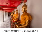 Details from statues of Buddha and monks in a temple in Bangkok