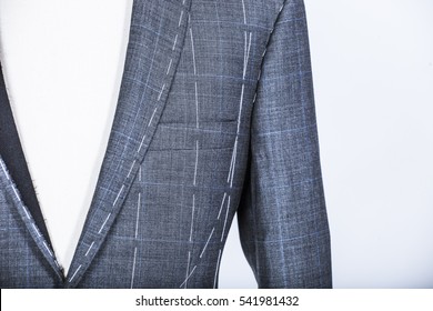 Details of a tailored suit jacket with markings on it for stitching, cutting and tailoring