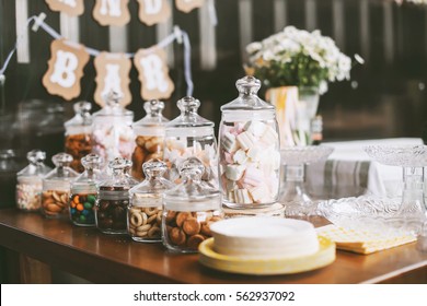 Details of a tasty candy bar with jugs of sweets, cookies and marshmallows