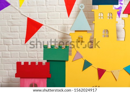 Details of the toy castle close-up. Toy castle is the backdrop for a photo shoot for a birthday. Photo zone with decorations for the birthday celebration for kids. Children's photo Studio for kids