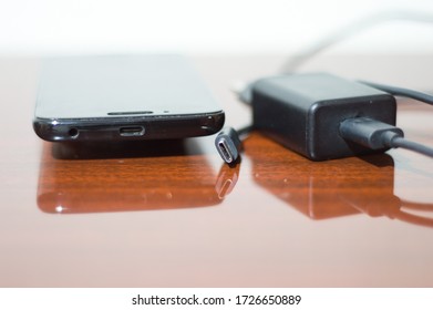 Details Of USB C Input, With Charger And Cell Phone Side By Side