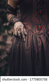 Details Of A Victorian Dress: Corset With Black Lace And Lace Gloves