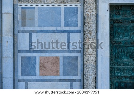 Details of the Western front and a section of the main portal of Pisa Cathedral, or Cattedrale di Santa Maria Assunta, in Piazza del Duomo – the Cathedral Square, unofficially known as Piazza dei Miracoli – in Pisa, Tuscany, Italy.