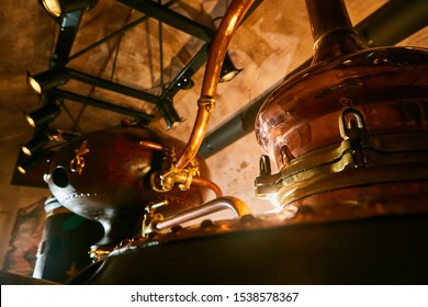 Detalis of medieval traditional distiller cube made from copper production of alcohol, cognac, whiskey. Fragment of copper old distiller for alcohol production. Ancient traditional food technologies