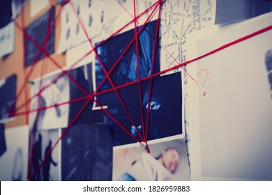 Detective Board With Crime Scene Photos And Red Threads, Closeup