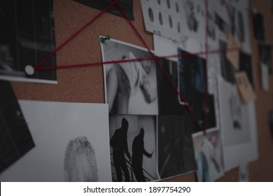 Detective Board With Crime Scene Photos, Stickers, Clues And Red Thread, Closeup