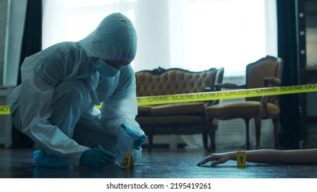 Detective Collecting Evidence In A Crime Scene. Forensic Specialists Making Expertise At Home Of A Dead Person. Homicide Investigation By Professional Police Officer.