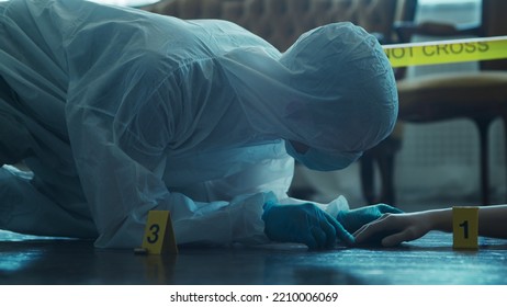 Detective Collecting Evidence In A Crime Scene. Forensic Specialists Making Expertise At Home Of A Dead Person. Homicide Investigation By Professional Police Officer.