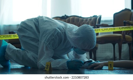 Detective Collecting Evidence In A Crime Scene. Forensic Specialists Making Expertise At Home Of A Dead Person. Homicide Investigation By Professional Police Officer.