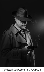 Detective Holding A Gun, He Is Wearing A Fedora Hat And A Trench Coat, 1950s Noir Film Character