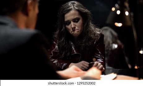 Detective interrogating crying lady, trying to get signed confession, punishment