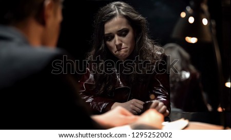 Detective interrogating crying lady, trying to get signed confession, punishment
