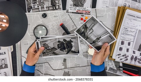 Detective to look at the tablet photos of criminals who recorded a hidden camera - Shutterstock ID 2068378331