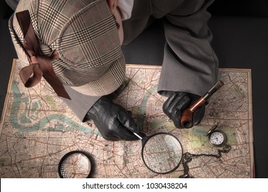 Detective man- magnifying glass, map of London, clock on chain
