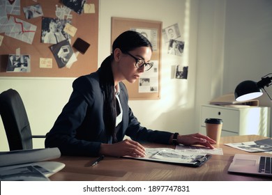 Detective Working At Desk In Her Office